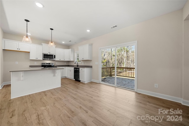 kitchen featuring a center island, white cabinets, light wood-type flooring, decorative light fixtures, and stainless steel appliances