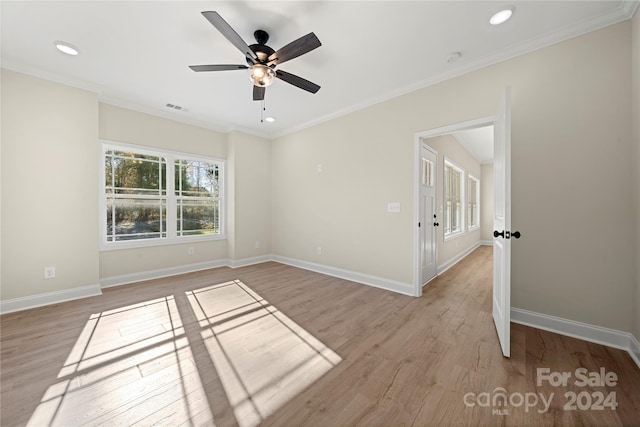 unfurnished room with light hardwood / wood-style flooring, ceiling fan, and ornamental molding