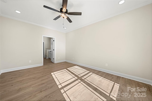 spare room featuring ornamental molding, a ceiling fan, baseboards, and wood finished floors