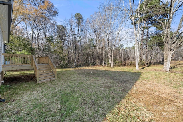 view of yard featuring a deck and stairway