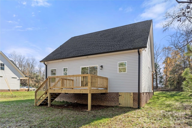 back of property with roof with shingles, a lawn, a wooden deck, and stairs