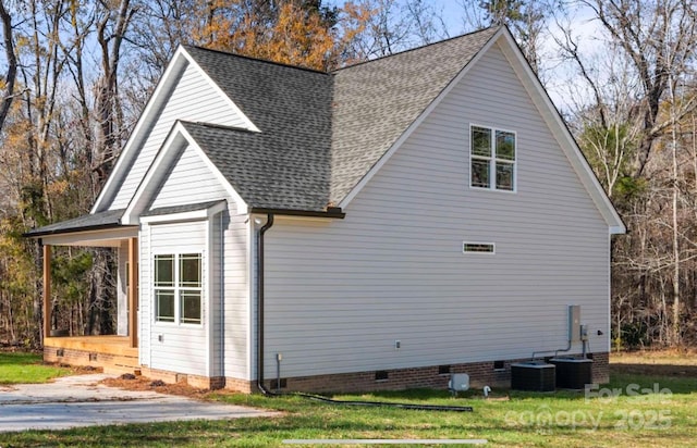 view of side of home featuring a shingled roof, crawl space, and central air condition unit