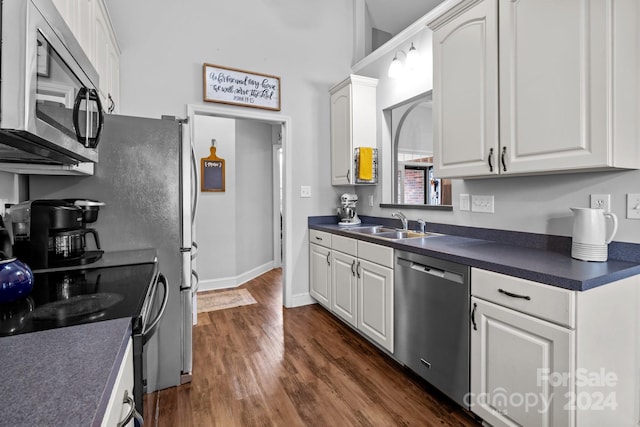 kitchen featuring white cabinetry, stainless steel appliances, sink, and dark hardwood / wood-style flooring