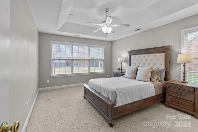 carpeted bedroom with multiple windows and ceiling fan