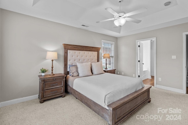 carpeted bedroom with ceiling fan and connected bathroom