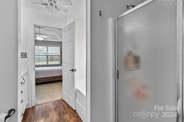 bathroom featuring hardwood / wood-style flooring, ceiling fan, and plus walk in shower