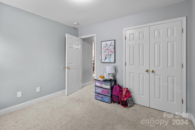 carpeted bedroom with a closet