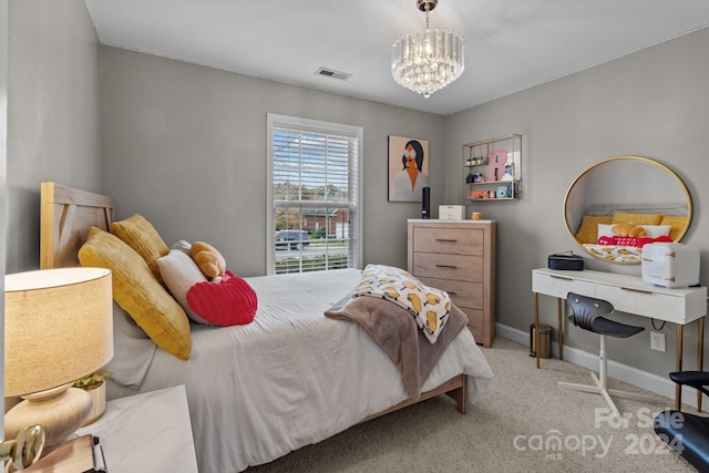 bedroom featuring light carpet and an inviting chandelier