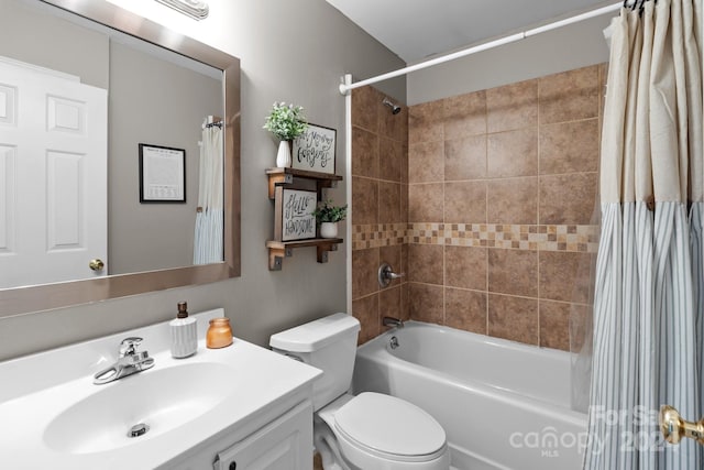 full bathroom featuring toilet, vanity, and shower / bathtub combination with curtain