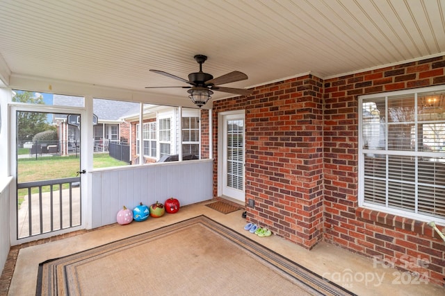 unfurnished sunroom with wooden ceiling and ceiling fan