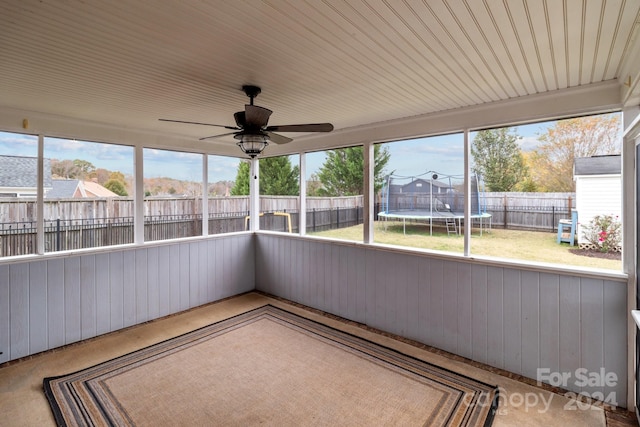 unfurnished sunroom with ceiling fan