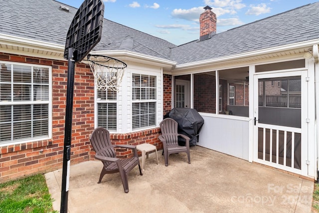 view of patio featuring area for grilling and a sunroom