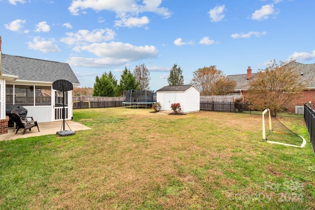 view of yard with a patio, a sunroom, a trampoline, and a storage shed