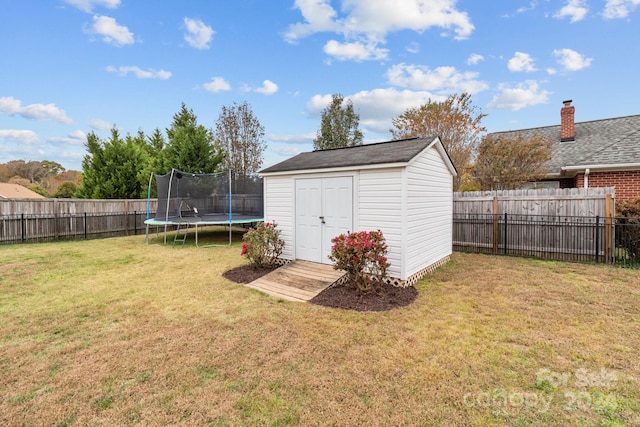 view of outbuilding featuring a yard and a trampoline