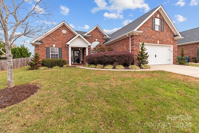 view of front of home featuring a garage and a front yard