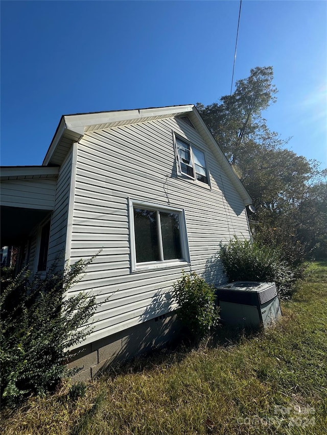 view of side of home with central AC unit