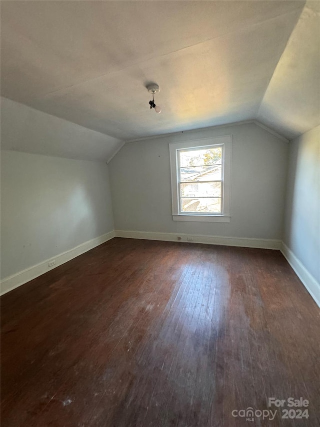 bonus room featuring dark wood-type flooring and lofted ceiling