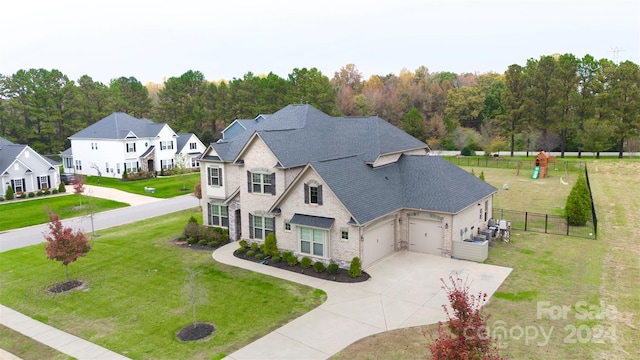 view of front of home with a front yard and a garage