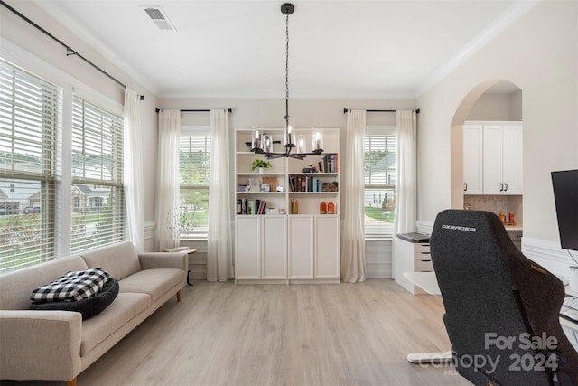 office space featuring light hardwood / wood-style floors, an inviting chandelier, and ornamental molding