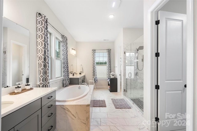 bathroom with vanity and independent shower and bath