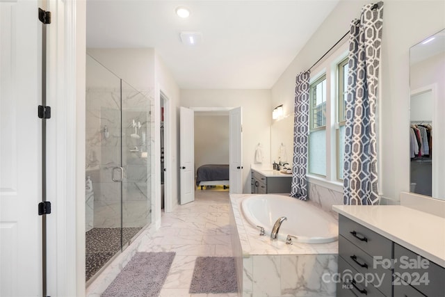 bathroom with vanity and separate shower and tub