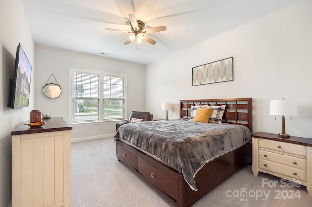 bedroom featuring light colored carpet and ceiling fan