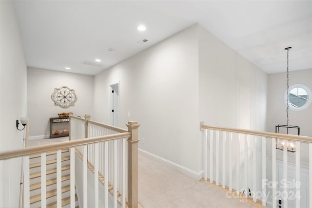 hall featuring light colored carpet