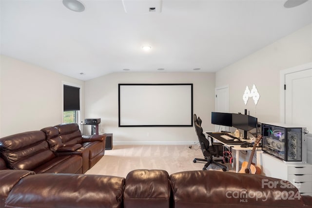 cinema featuring light carpet and vaulted ceiling