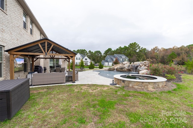 view of yard featuring a gazebo, an outdoor hangout area, and a patio