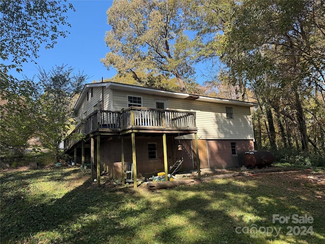 back of house with a yard and a deck