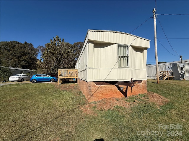 view of side of home featuring a lawn