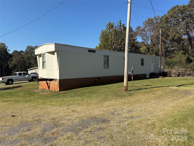 view of side of home featuring a yard