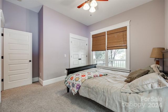 bedroom with ceiling fan and light carpet