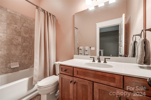 full bathroom with vanity, toilet, and shower / bath combo with shower curtain