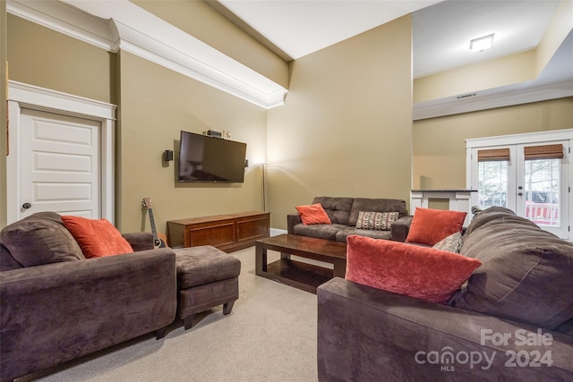 carpeted living room featuring ornamental molding and french doors