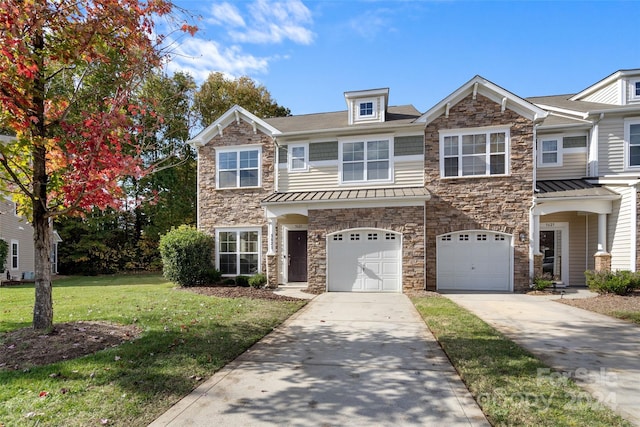 townhome / multi-family property featuring a front lawn and a garage