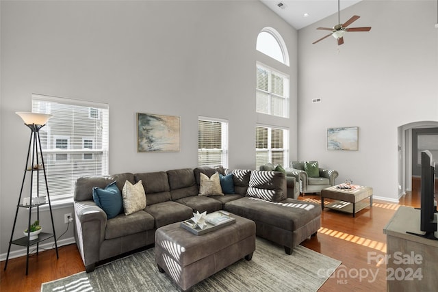 living room featuring a healthy amount of sunlight, ceiling fan, high vaulted ceiling, and hardwood / wood-style floors