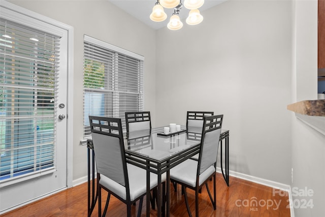 dining space featuring an inviting chandelier and dark hardwood / wood-style floors