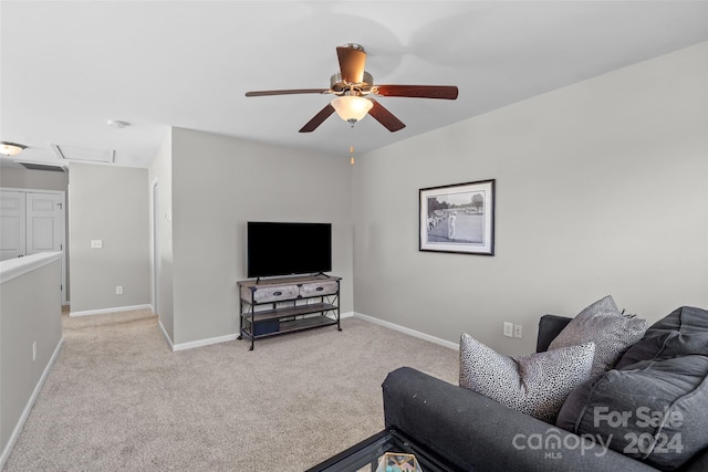 living room featuring ceiling fan and light colored carpet