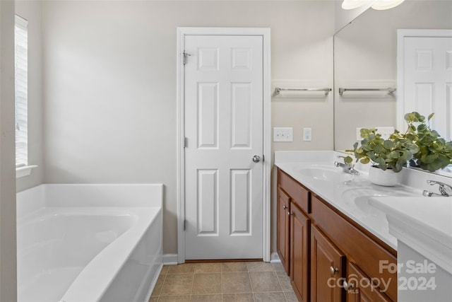 bathroom with vanity, a tub to relax in, and tile patterned flooring