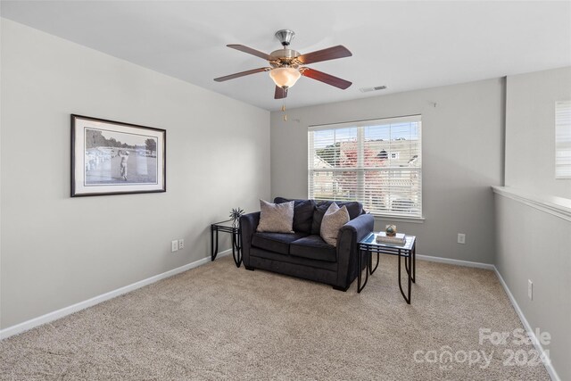 carpeted living room featuring ceiling fan