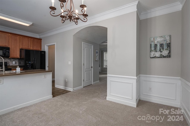 kitchen featuring crown molding, black appliances, hanging light fixtures, and dark carpet