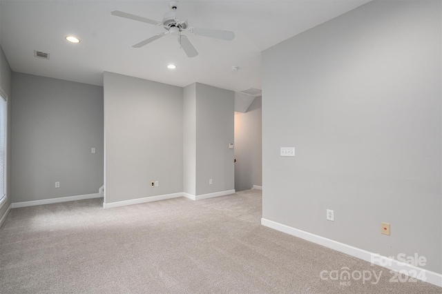 spare room with light colored carpet and ceiling fan