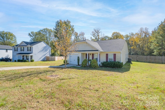 view of front of house with a front lawn, central AC unit, and a garage