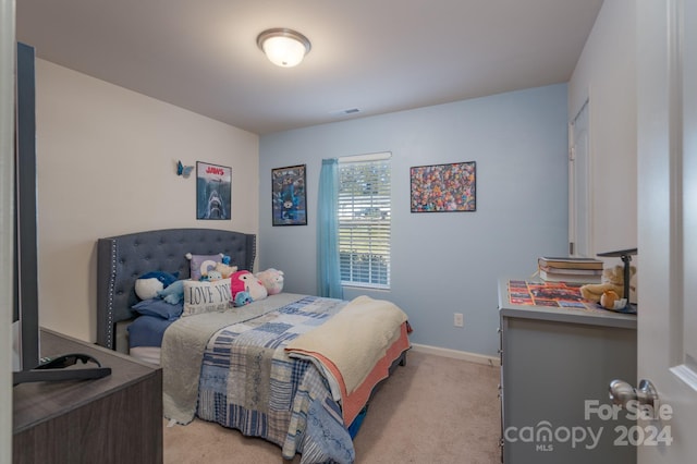 bedroom featuring light carpet