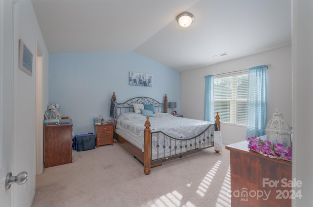 carpeted bedroom with vaulted ceiling