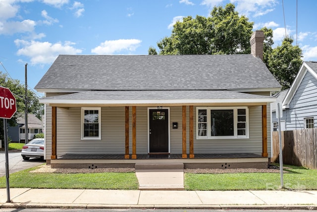 201 Mccubbins St, Salisbury, NC 28144 - bungalow-style home featuring a porch, fence, a shingled roof, and a chimney