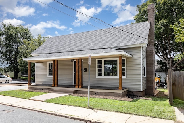 201 Mccubbins St, Salisbury, NC 28144 - bungalow-style house with fence, a shingled roof, a front lawn, a porch, and a chimney