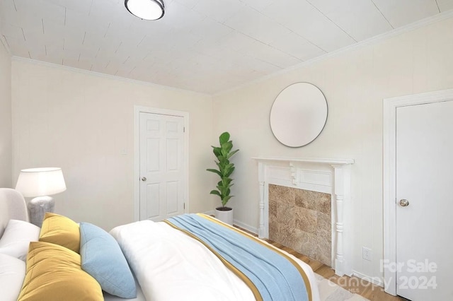 bedroom with crown molding and hardwood / wood-style flooring