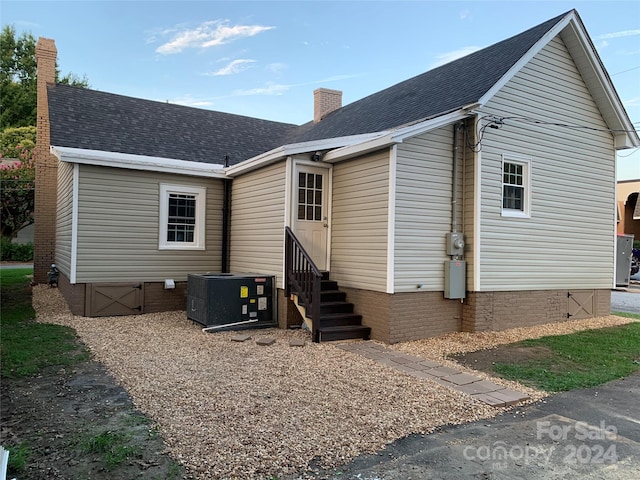 rear view of property with cooling unit